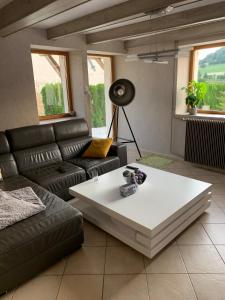 a living room with a couch and a coffee table at maison en campagne in Vernois-lès-Belvoir