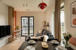 a living room with a couch and a table at Trevi Apartments Katowice in Katowice