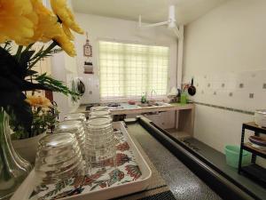 een keuken met een aantal glazen potten op een aanrecht bij Bayu Biru 2 Bedroom Unit Pool View Balcony in Kampong Tanah Merah +1 foto