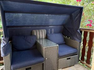 a wicker house with two chairs and a table at Golden Wave Apartment in Vir
