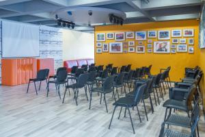 a conference room with chairs and a projection screen at Mobility Friends Hostel in Barcelos