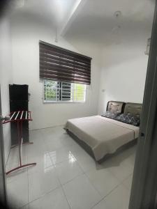 Ένα ή περισσότερα κρεβάτια σε δωμάτιο στο Epal Homestay Muadzam Shah