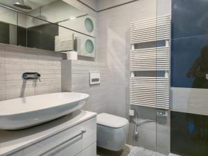 a white bathroom with a sink and a toilet at Apartment Iva in Omiš +48 photos