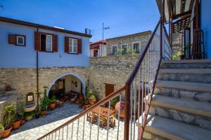 a staircase leading up to a house with a patio at Theodorou Stone House in Pano Lefkara