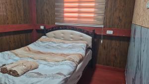 a bed with a blanket on it in a room at נוף הכפר - 6 חדרי אירוח לזוגות ומשפחות עם ג'קוזי ובריכה מחוממת משותפים במתחם in Buq‘ātā +5 photos