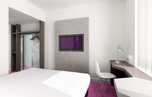 a bedroom with a white bed and a tv on the wall at VISIONAPARTMENTS Place de Cornavin - self check-in in Geneva