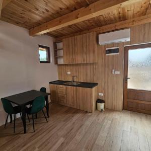 a kitchen with a sink and a table with chairs at VM Apartments Zabljak in Razvršje +77 photos