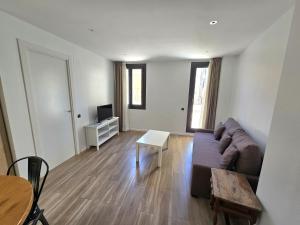 a living room with a couch and a table at SM Apartments Station in Lleida
