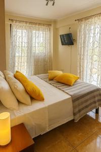 a bedroom with two beds with yellow pillows at Filiatra Cozy Cental Retreats with Balconies in Filiatra