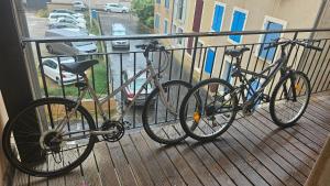 two bikes chained to a railing on a balcony at Gruissan Village APPT Duplex 51m2 in Gruissan