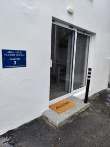 a door to a building with a sign on it at Aran View Holiday Homes apartment in Doolin