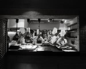 a group of chefs preparing food in a kitchen at Churchill Townhouse in Bodrum City