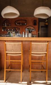 a bar with wicker chairs and a wooden counter at Churchill Townhouse in Bodrum City