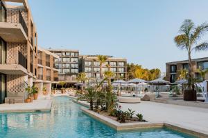 a resort with a swimming pool and some buildings at Bonito Ibiza by NCalma Hotels in San Antonio +67 photos