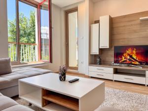 a living room with a fire in the fireplace at Luxury apartment 304 - next to Sarajevo City Center in Sarajevo