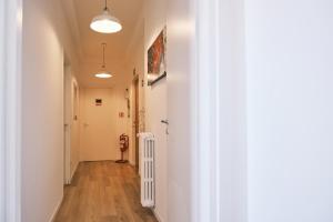 a hallway with white walls and a white radiator at Milano 71 in Milan