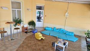 a living room with a blue couch and chairs at Hotel Vila Ružica- glavna zgrada i depandanse in Crikvenica