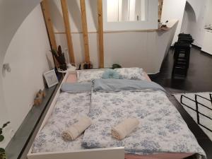 two beds are sitting in a room at F16Studió Apartman in Pécs