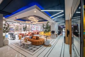 a lobby with a large couch in a room at Metro Hotel Phahonyothin 35 in Bangkok