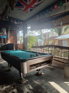 a pool table sitting inside of a building at Thousands of Bottles - Hostel and Trekking in Bukit Lawang