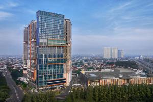 a tall building in a city with a bridge at Four Points by Sheraton Bekasi in Bekasi