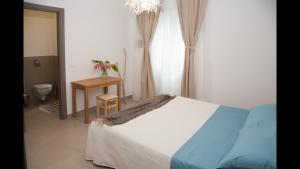 a bedroom with a bed and a table and a window at SulMare Alba Adriatica in Alba Adriatica