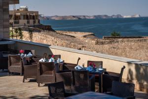a restaurant with tables and chairs on a balcony at Retac Abu Simbel Nefertari Hotel in Abu Simbel