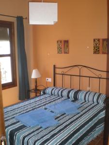 a bedroom with two beds and a window at Apartamentos Rurales El Cañuelo de Carcabuey in Carcabuey