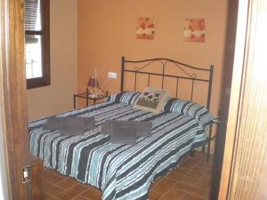 Postel nebo postele na pokoji v ubytování Apartamentos Rurales El Cañuelo de Carcabuey