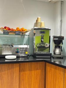 a kitchen with a coffee maker and oranges on a counter at Safestay Glasgow Charing Cross in Glasgow