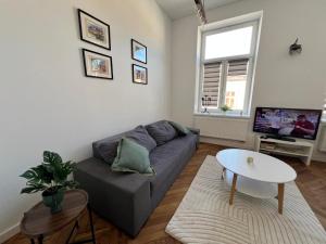 a living room with a couch and a table at Pod Bimą in Tarnów