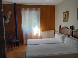 Posteľ alebo postele v izbe v ubytovaní Balneario Caldas de Luna