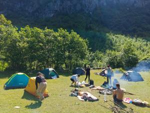 a group of people in a field with tents at North wild camping in Shkodër +14 photos