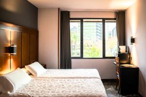 Postel nebo postele na pokoji v ubytování Hotel Condestable Iranzo