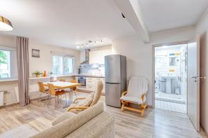 a kitchen and living room with a couch and a table at Vienības Family. in Jūrmala