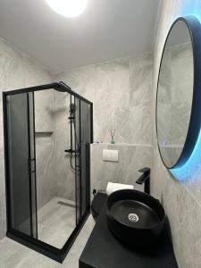 a bathroom with a black sink and a mirror at Pristina Luxury Apartments 45 in Pristina +5 photos