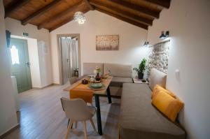 a living room with a couch and a table at Agnanti Studios in Roussopoúlion