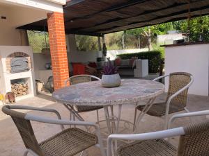 a table and chairs on a patio with a fireplace at Casa Rural Y Spa de Regina in Turballos