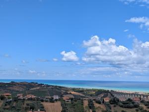 a view of the ocean and a city at Appartamento spazioso montone vista mare in Montone
