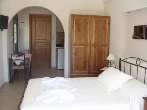 a bedroom with a bed with towels on it at Anastasia Studios in Avlemonas