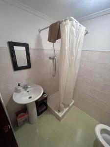 a bathroom with a sink and a shower curtain at Casa Senderuela by CARDI Suites in Valdelinares