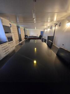 a living room with a large table and a couch at Péniche LOFT la campanella in Maizy