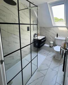 a bathroom with a shower and a toilet and a sink at Country Getaway on the Broads with Hot Tub and Fire Pit in Burgh Saint Margaret +16 photos