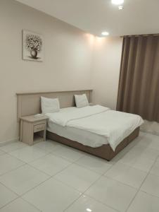 Giường trong phòng chung tại قمة الفخامة 2 للشقق المخدومة