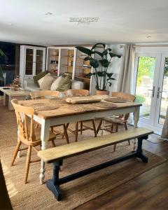 a table and chairs in a living room at Country Getaway on the Broads with Hot Tub and Fire Pit in Burgh Saint Margaret