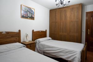 Posteľ alebo postele v izbe v ubytovaní Panther Home Apartamentos Anita
