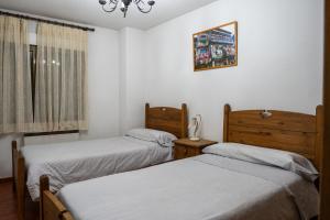 Posteľ alebo postele v izbe v ubytovaní Panther Home Apartamentos Anita