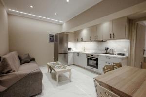 a kitchen and living room with a couch and a table at Victoria apartments in Chios