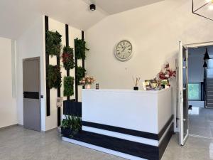 a lobby with a counter and a clock on the wall at Chicago Hotel in Yaremche +82 photos