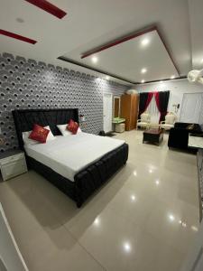 a bedroom with a large bed and a living room at Mountains escape in Murree +2 photos